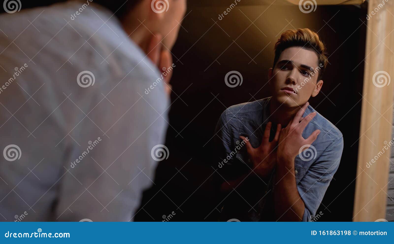 Upset Gender Fluid Person Looking in Mirror and Crying Self identity Upset Gender Fluid Person Looking in Mirror and Crying Self identity