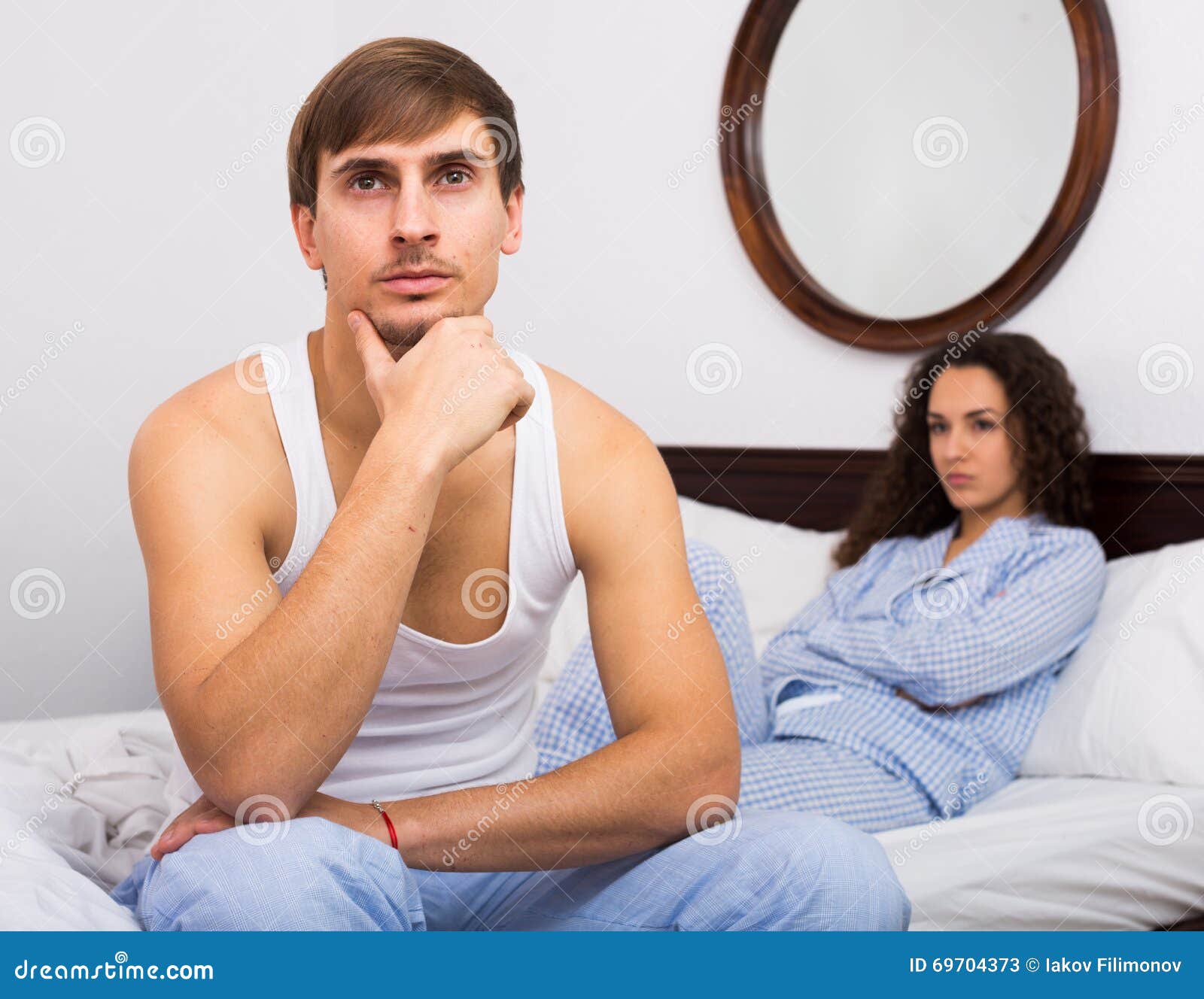 Upset Husband and Angry Wife in Bed Stock Image pic