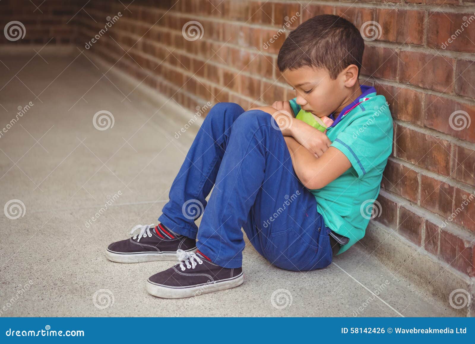 upset lonely child sitting by himself