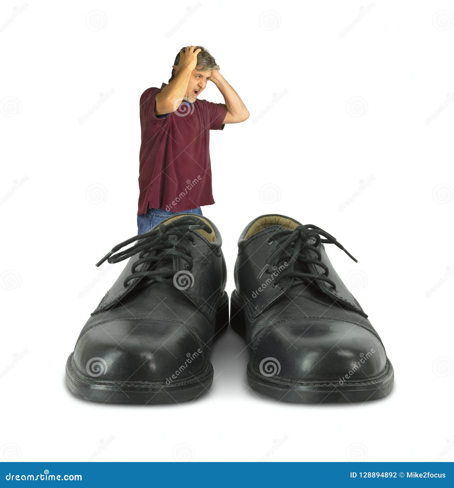 Upset Man Standing In Front Of Some Big Shoes To Fill