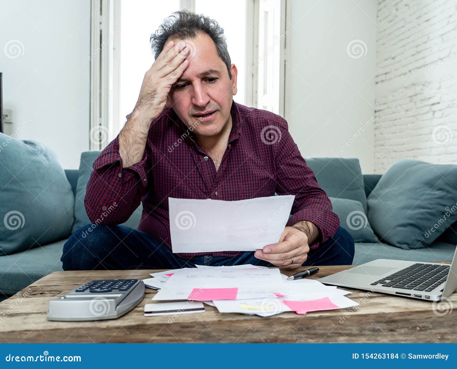 upset middle aged man stressed about credit card debts and payments not happy accounting finances