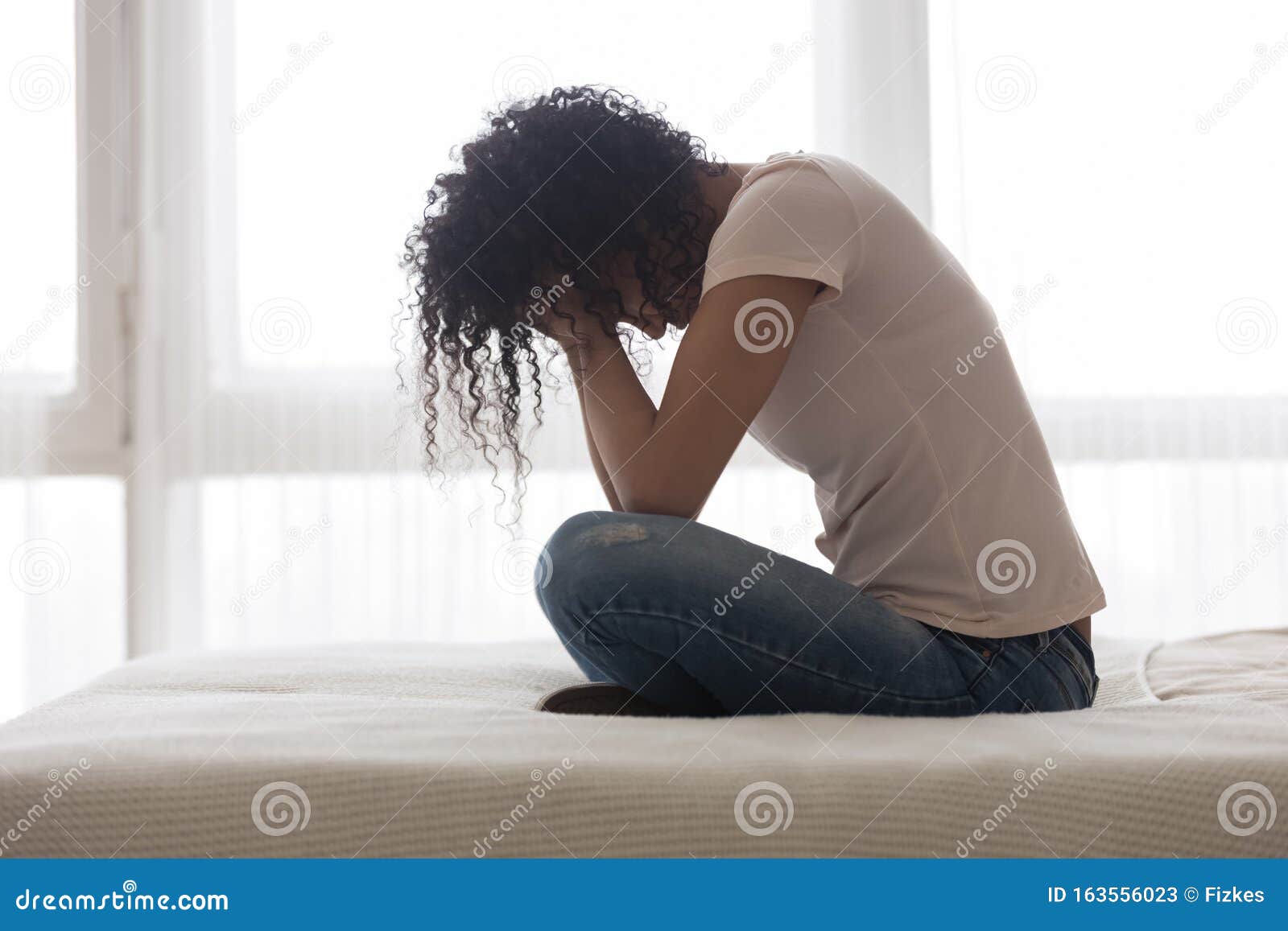 upset sad african american woman suffering from loneliness side view