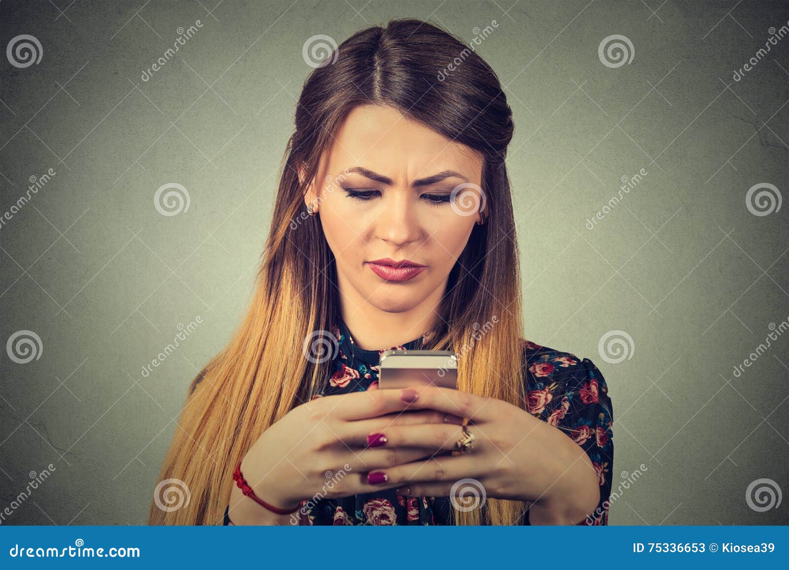 upset woman holding cellphone. sad looking girl texting on smartphone