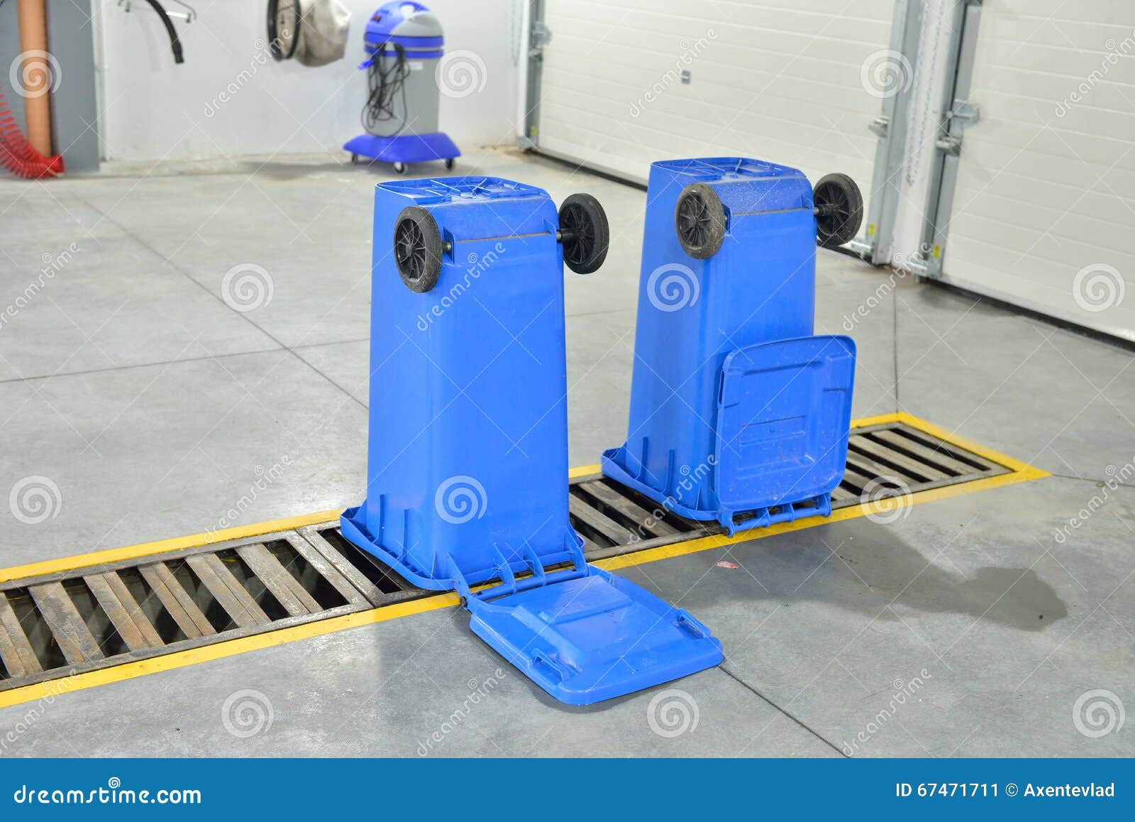 An Upside Down Blue Recycling Container on a Car Wash. Cleaning Stock