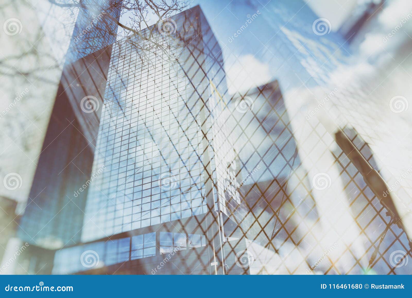 urban abstract background of glass skyscrapers with reflected sky in the windows