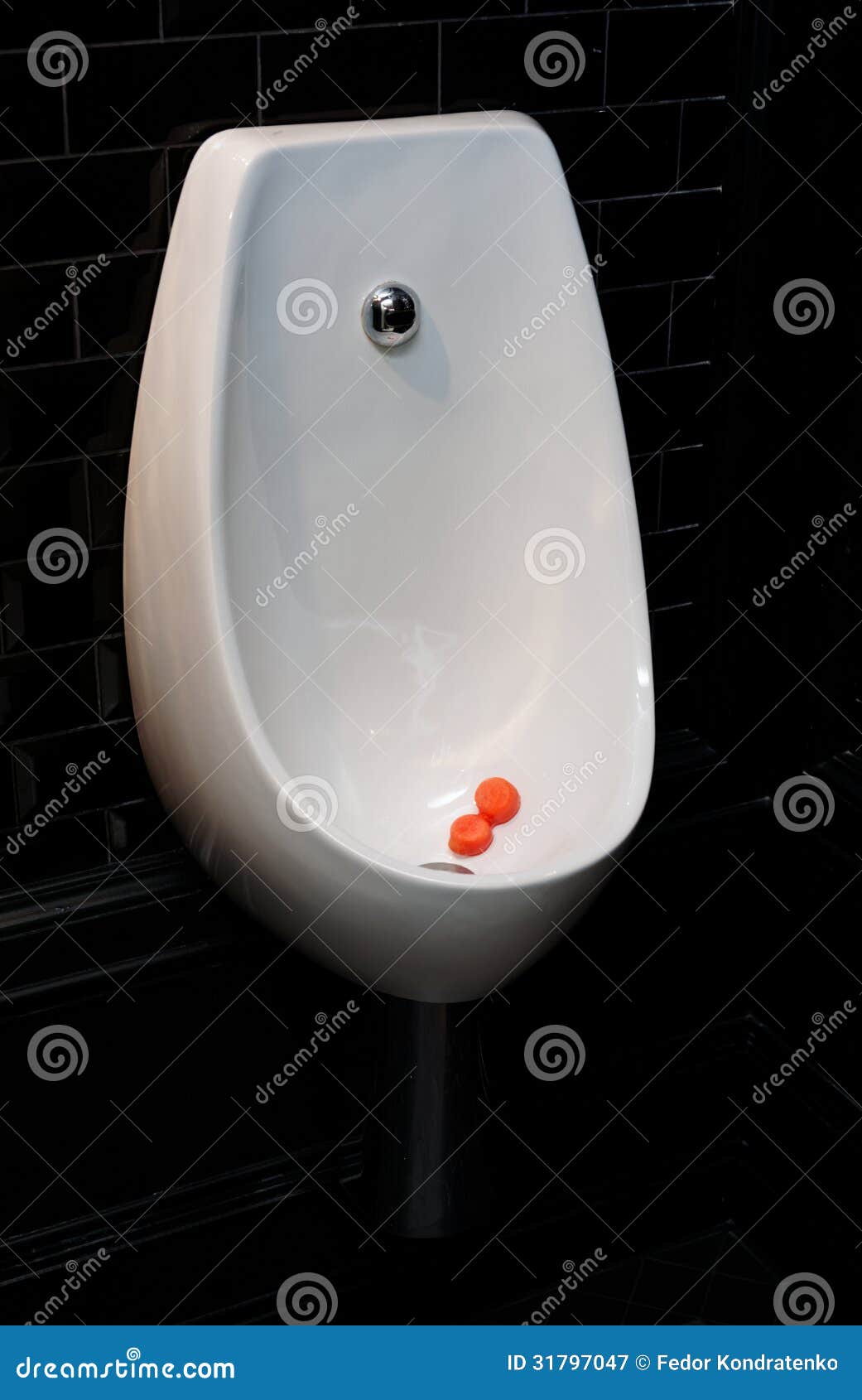 Urinal Bowl with Antiseptic Tablets in Dark Restroom Stock Image