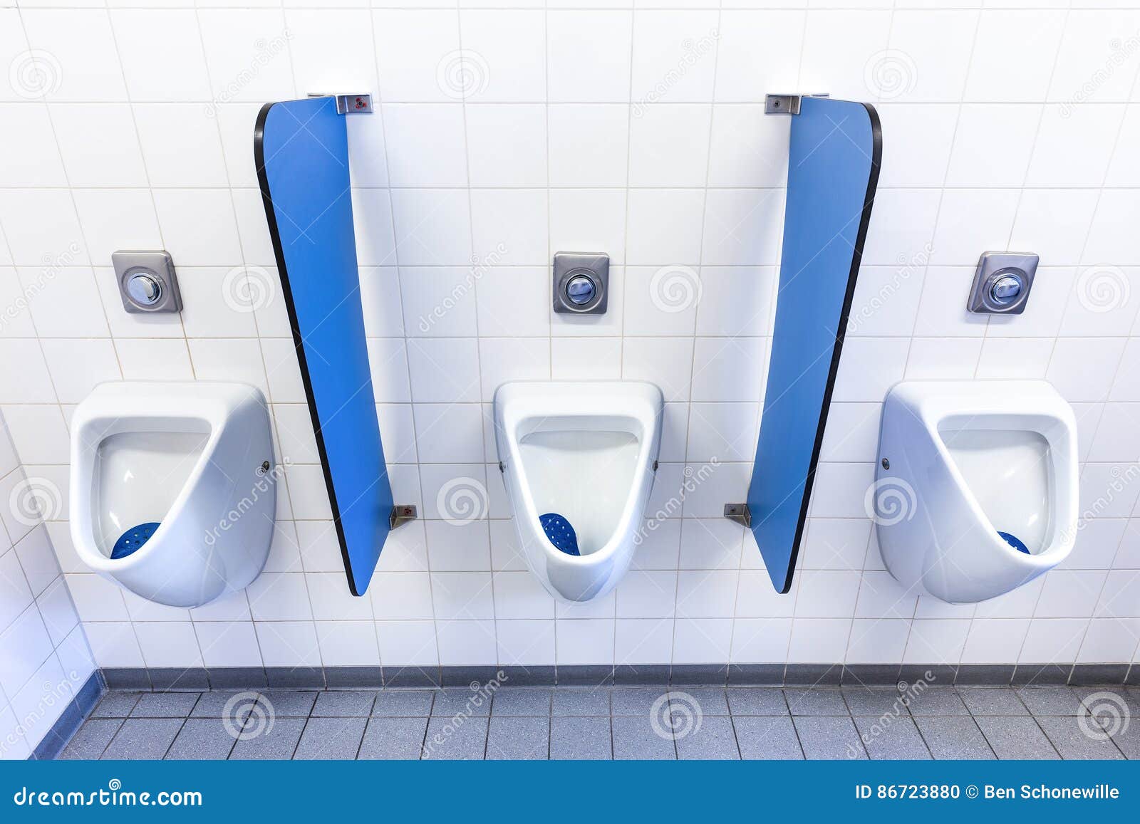 urinals for men on white wall with blue partitions