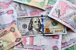 US Dollar Banknote On Top Of UAE National Currency Top View Of Mixed 