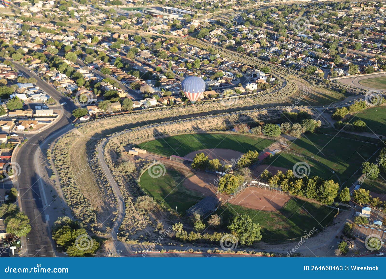 usa-themed hot air balloon over a little league baseball park in albuquerque city, new mexico