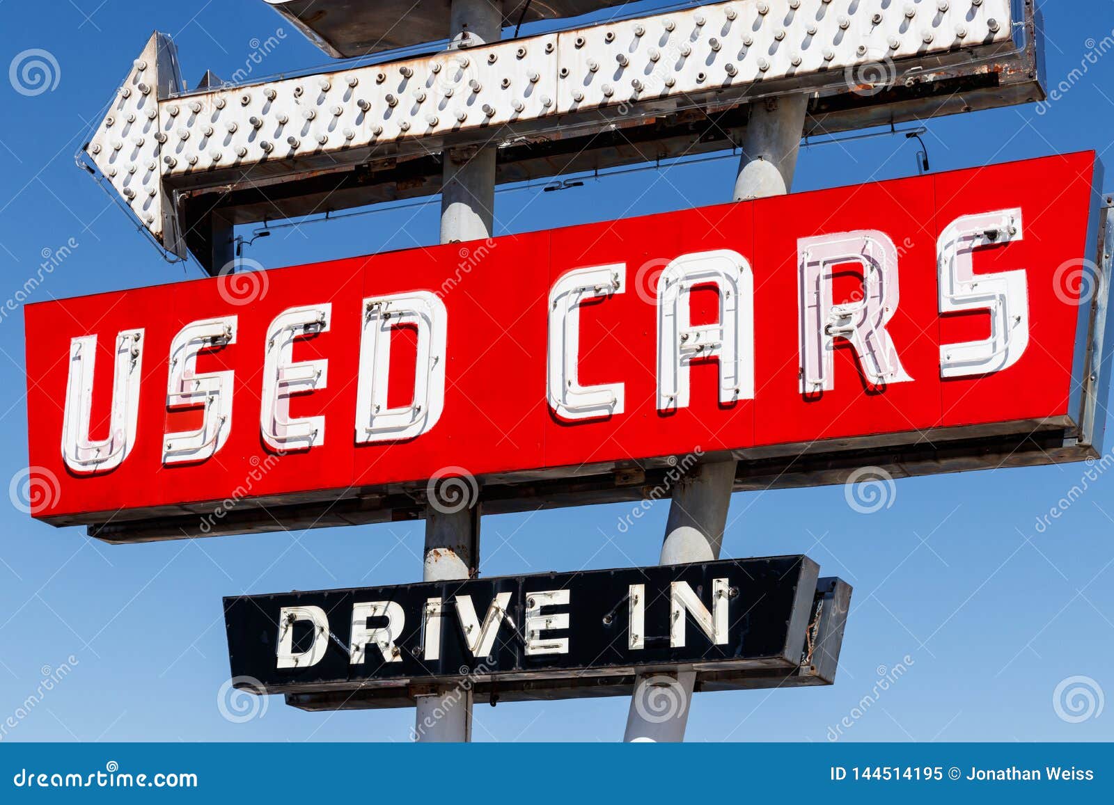 used car drive in neon sign from the 50s at a pre owned car dealership i