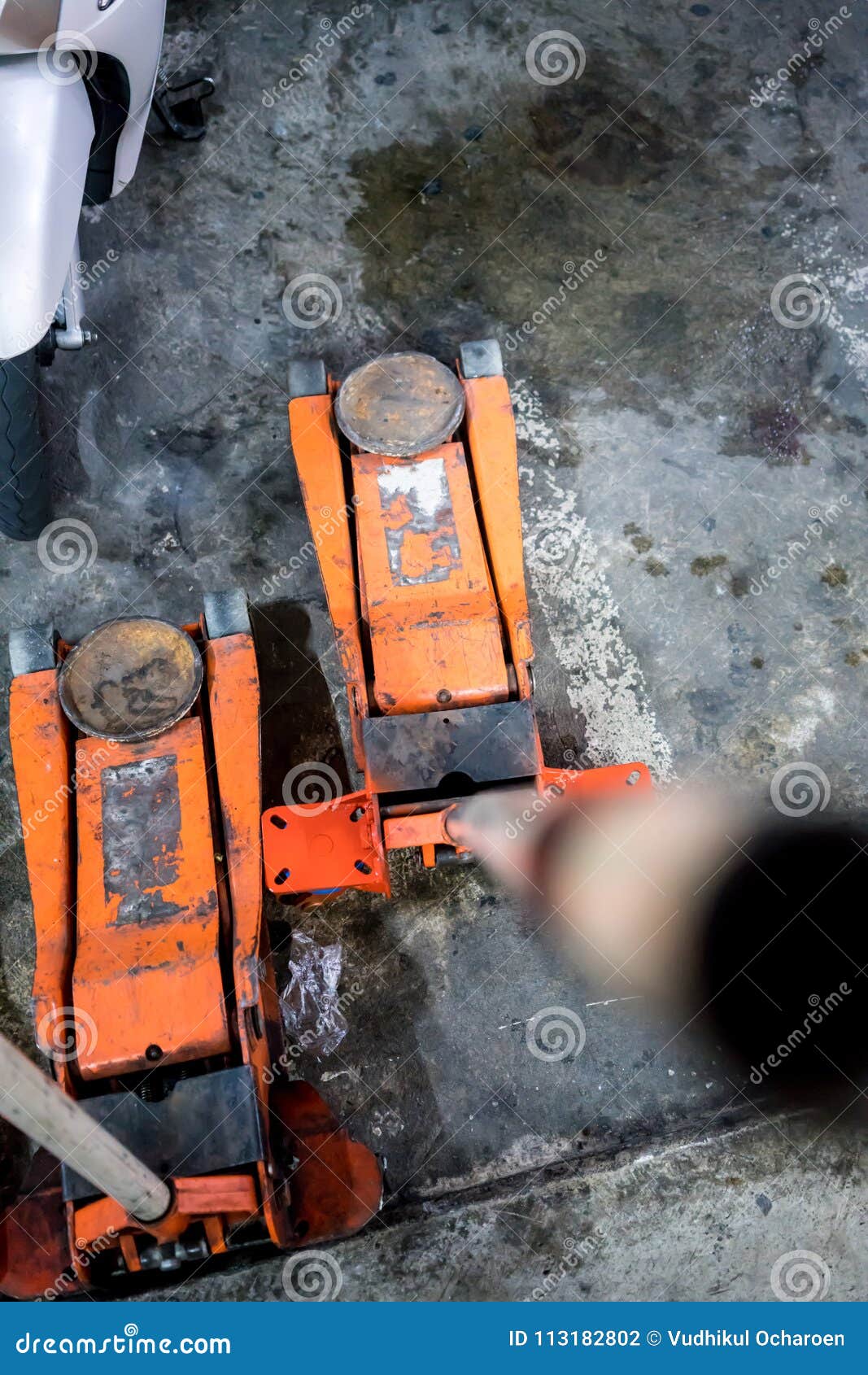 Used Orange Hydraulic Floor Jacks On Concrete Floor Stock Photo