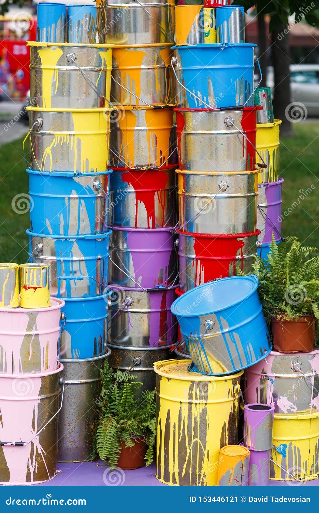 The Used Paint Cans. Many Multicolored Buckets with Traces of Paint on