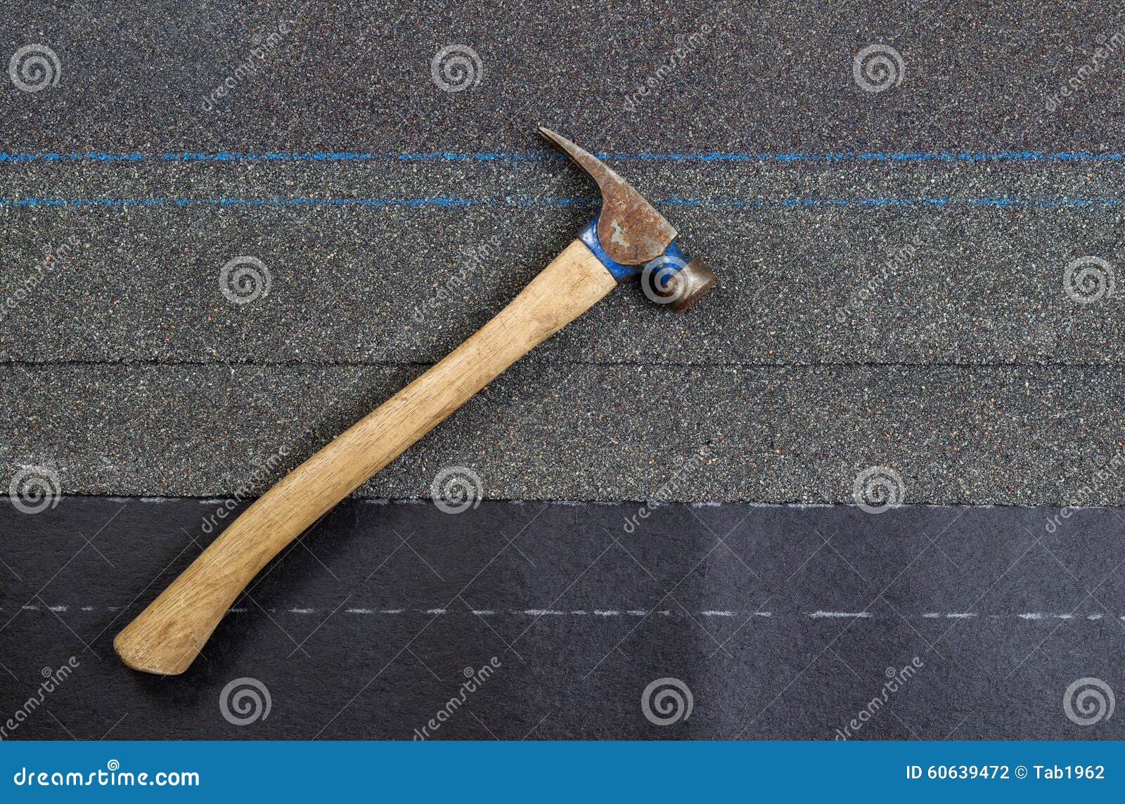 Used Roofing Hammer with New Composite Shingles on Felt Paper Stock