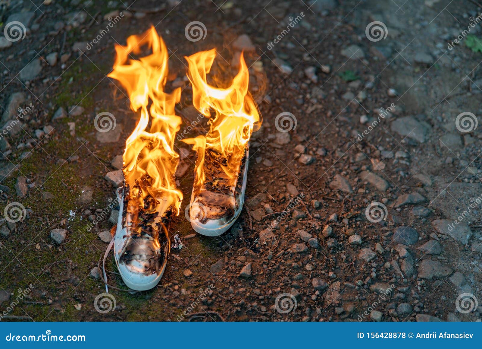 Used White High Sneakers Burning on a Rural Road that Runs in the ...