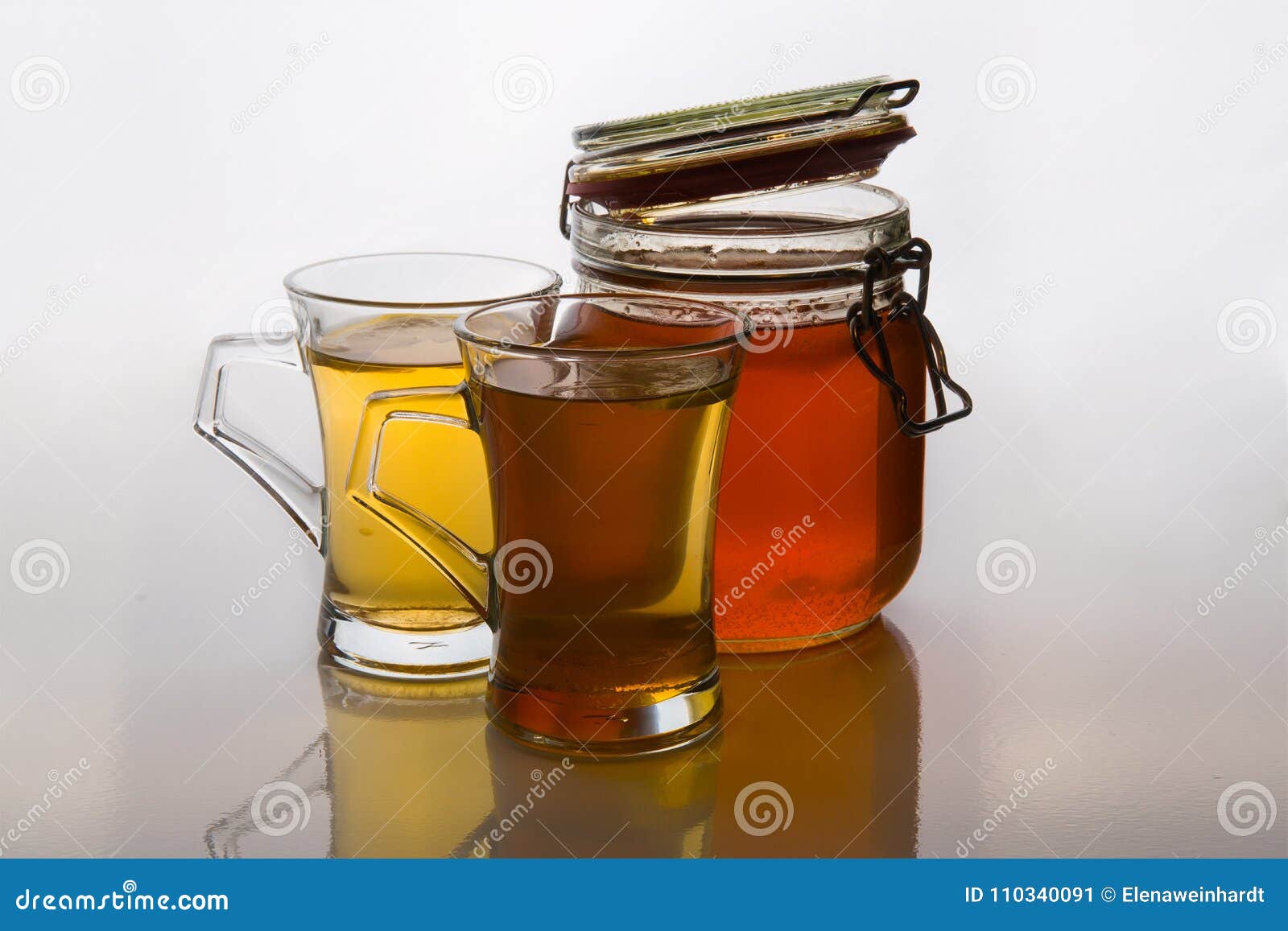 green tea in glass cups with honey and lemon on white background with mint