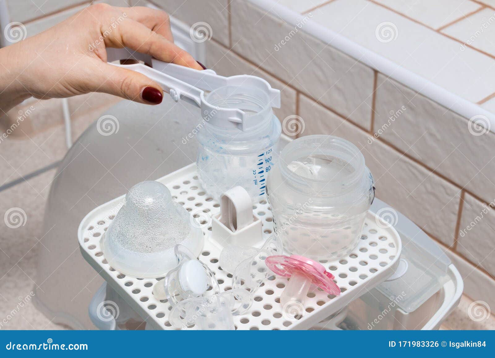 Using Baby Bottle Sterilizer Stock Photo Image of mother, liquid