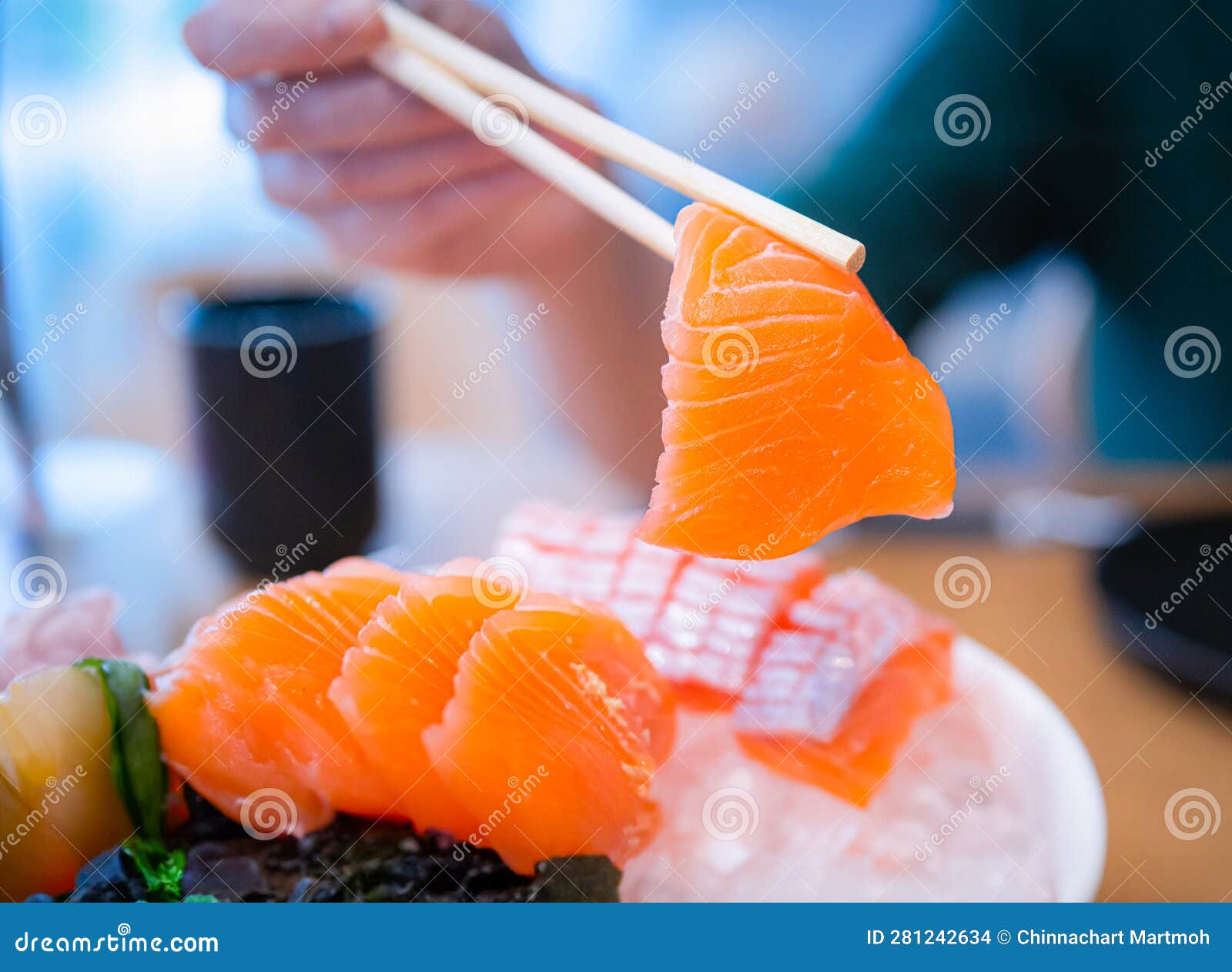 Using Chopsticks, Salmon Sashimi. Sashimi is a Popular Dish of Japanese
