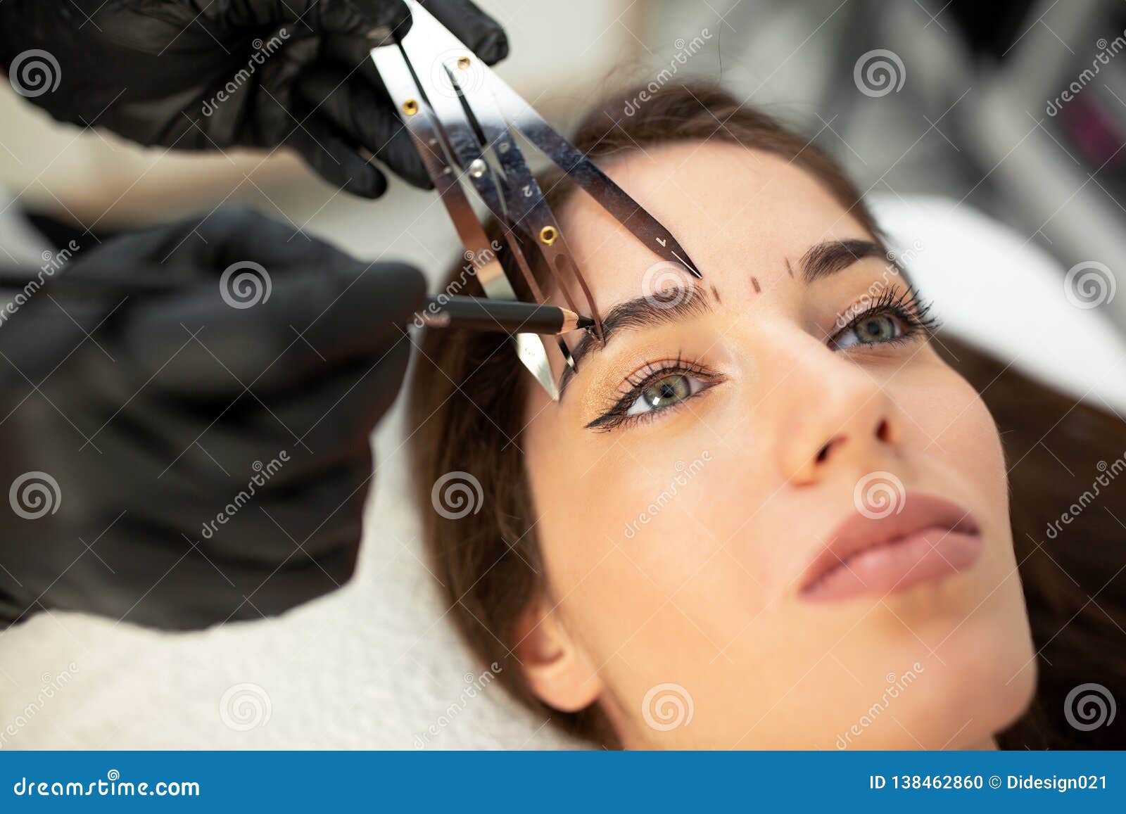 using cosmetics tools for taking the correct measure of future eyebrows