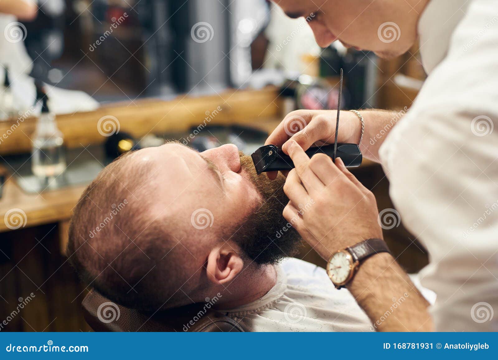Male Client with Beard Sitting in Hairdresser Chair. Serious Man with