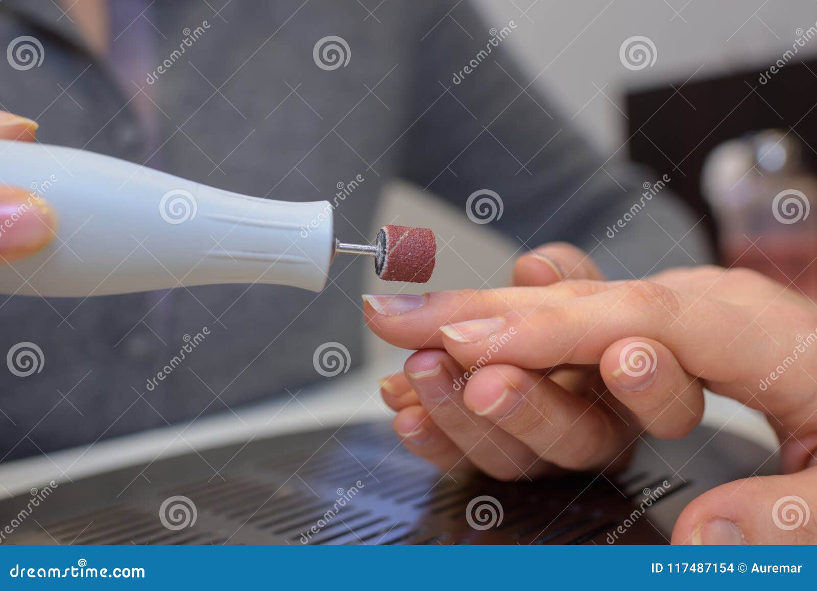 Using electronic nail file stock photo. Image of colour 117487154