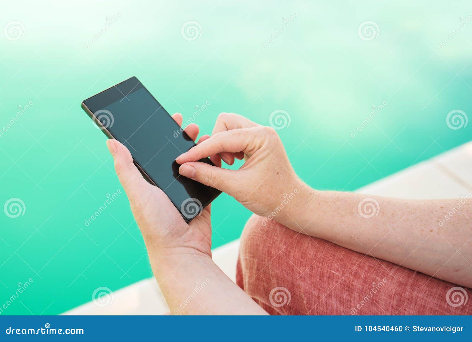 Using Mobile Phone by the Swimming Pool Stock Photo Image of
