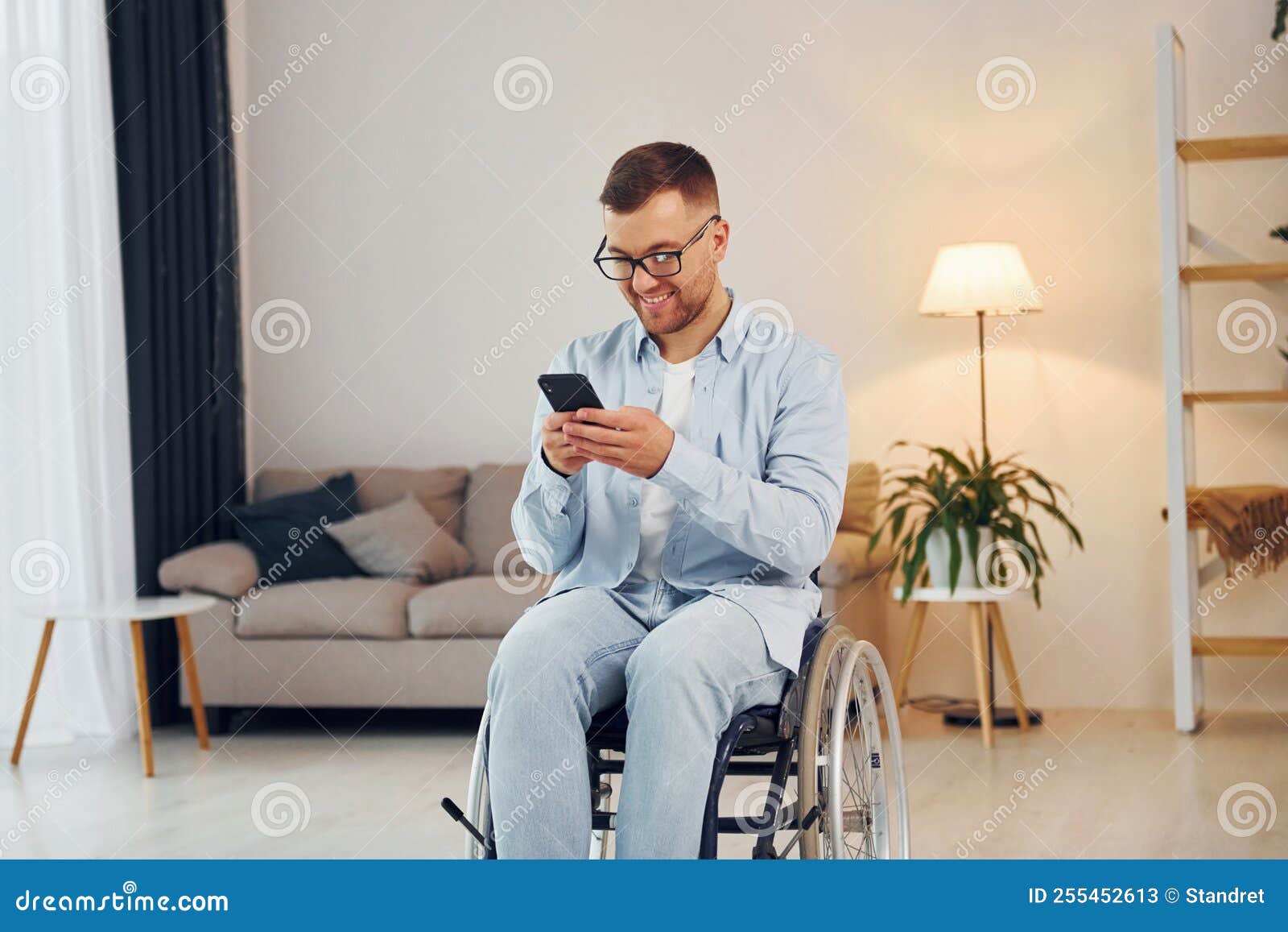 Using Phone. Disabled Man in Wheelchair is at Home Stock Image Image