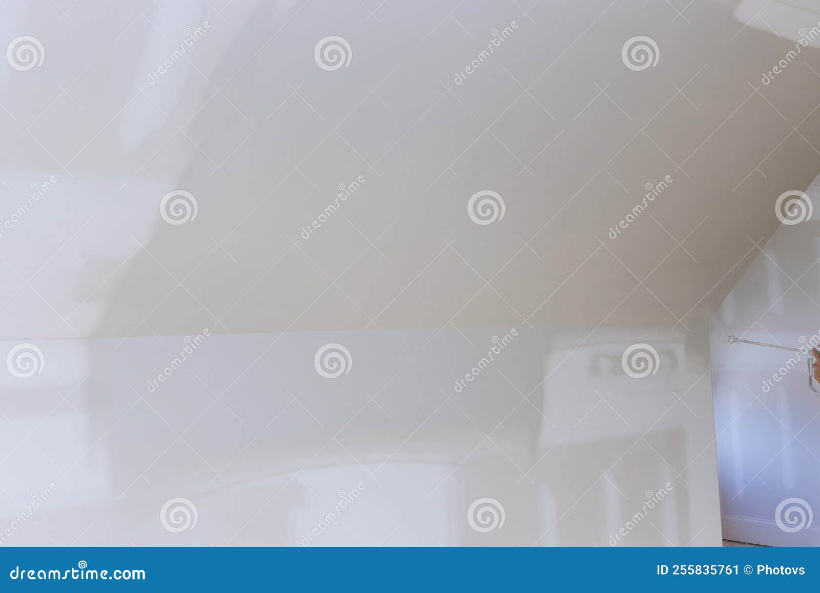 Using a Spray Gun Equipped with a Primer, the Worker Paints Walls and