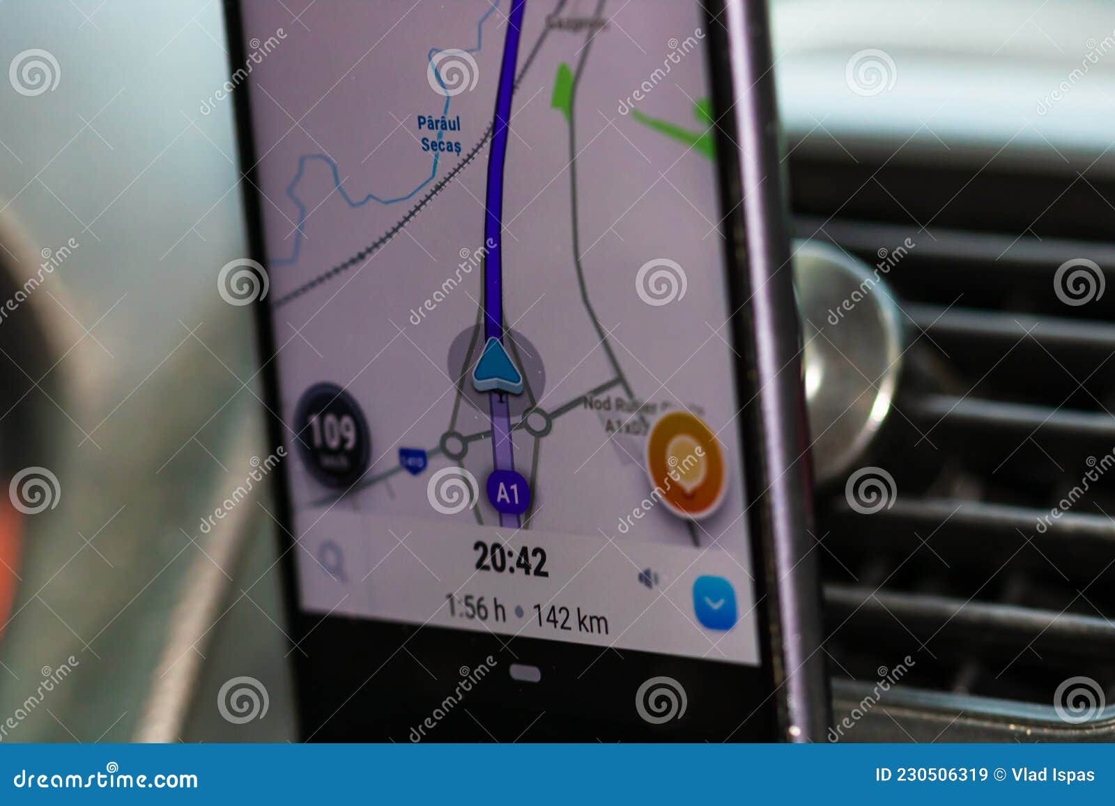 Using Waze Maps Application On Smartphone In Car Dashboard. Driver