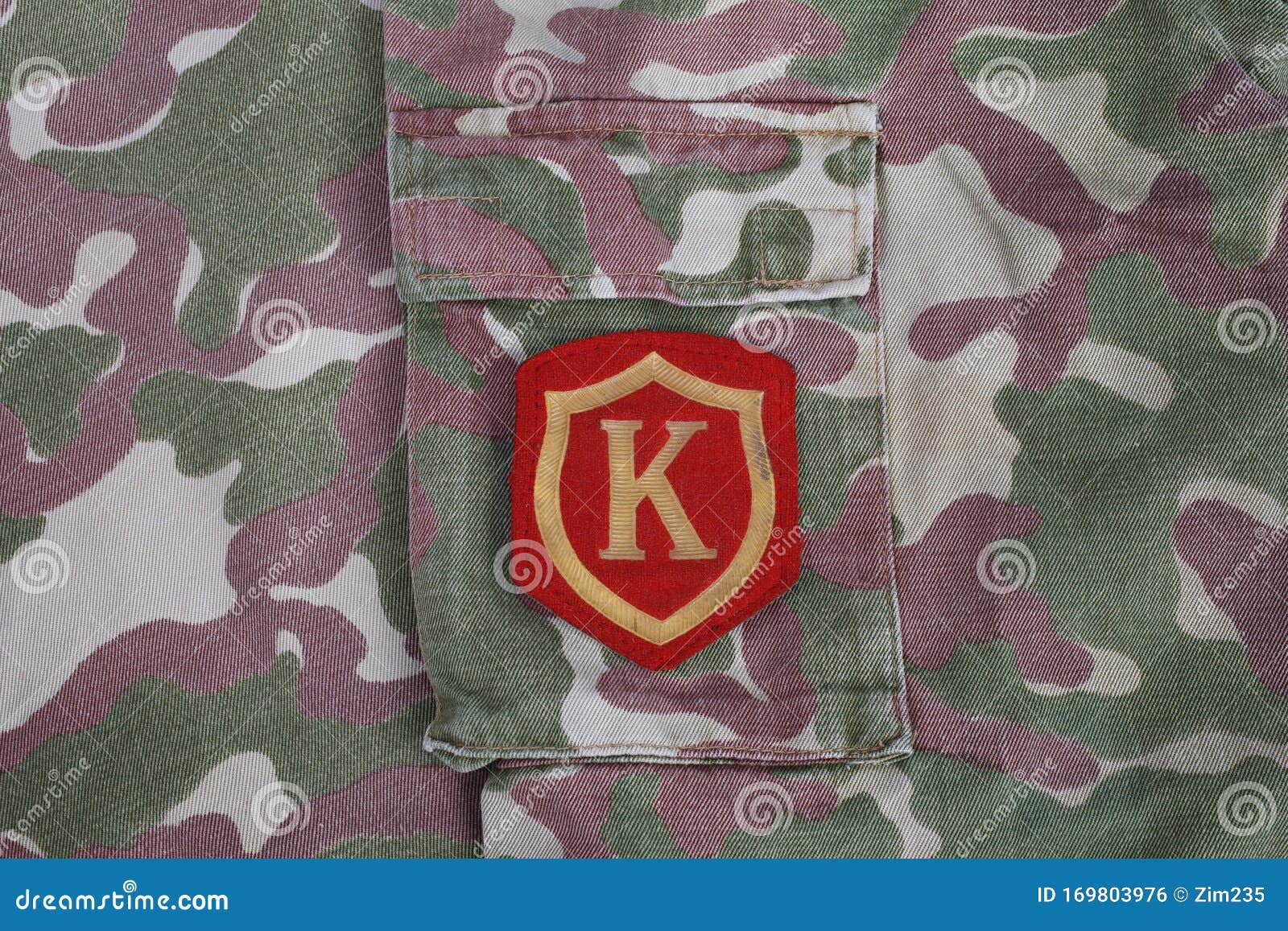 ussr military uniform - soviet army commandant shoulder patch on camouflage uniform background