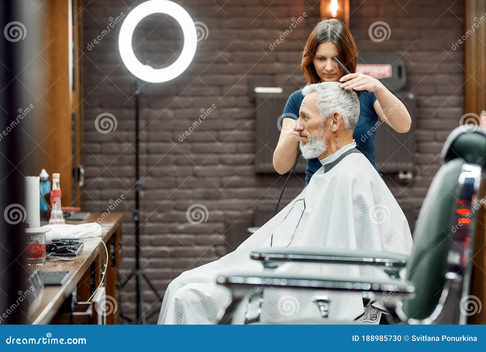 Usual Day at Barbershop Young Barber Girl Cutting Hair of Handsome Usual Day at Barbershop Young Barber Girl Cutting Hair of Handsome