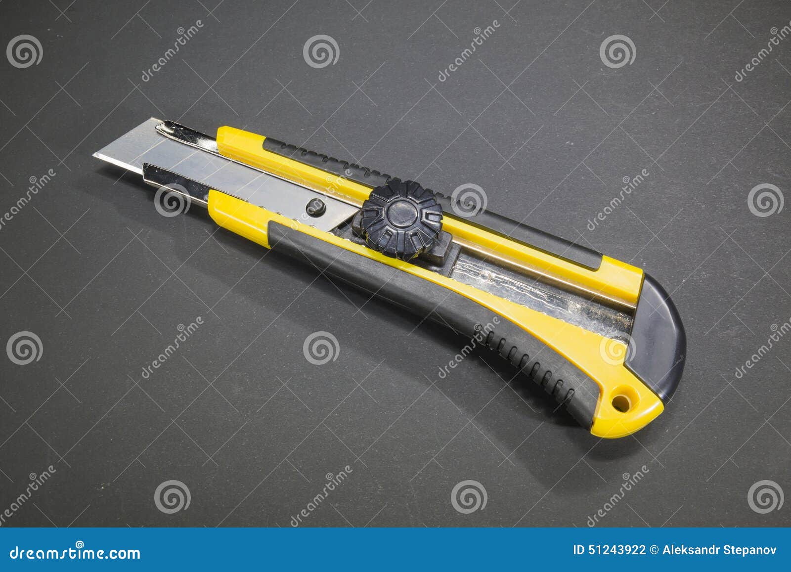 Utility Knife with Yellow Plastic Handle and Rubber Insert Stock Photo