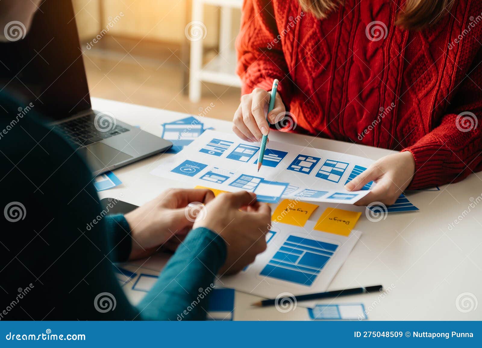 ux developer and ui er brainstorming about mobile app interface wireframe  with customer breif and color code at