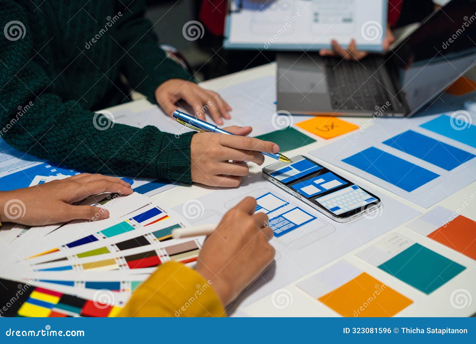 ux developer and ui er brainstorming about mobile app interface wireframe  with customer breif and color code, user