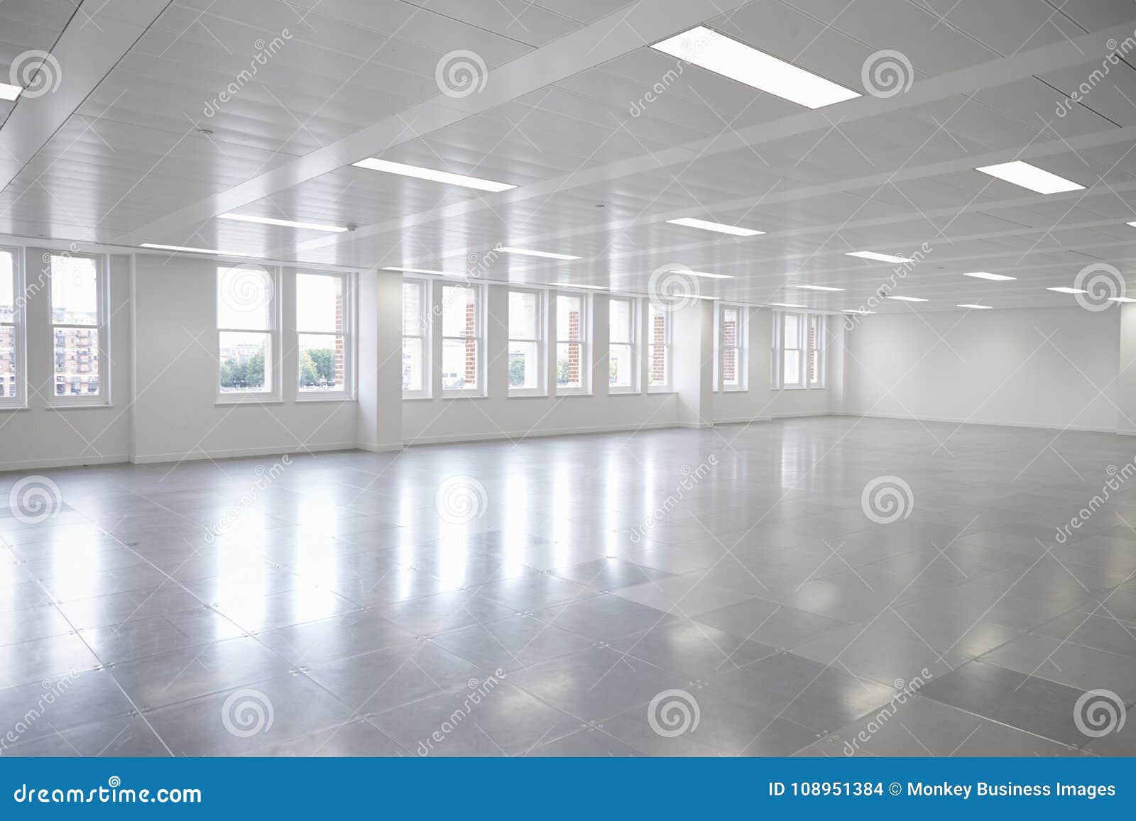 vacant open plan office space with windows