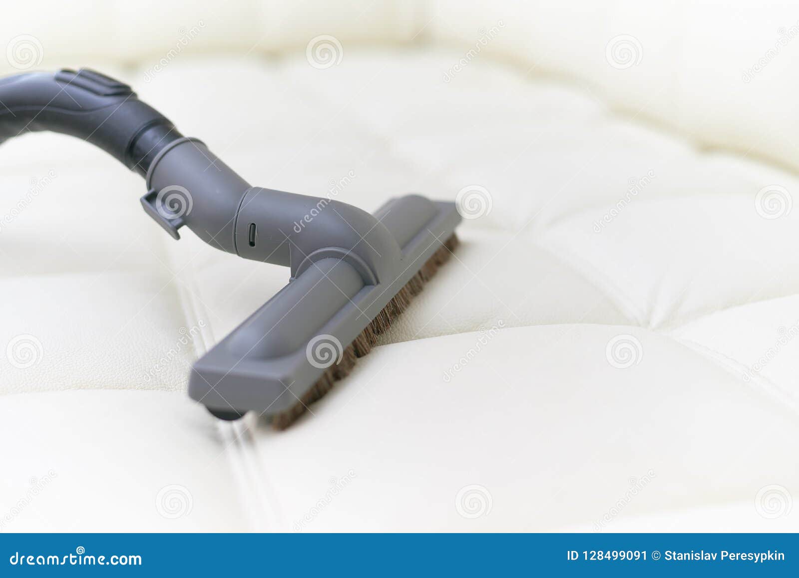 The Vacuum Cleaner Brush is on the Leather Sofa. Stock Image Image of