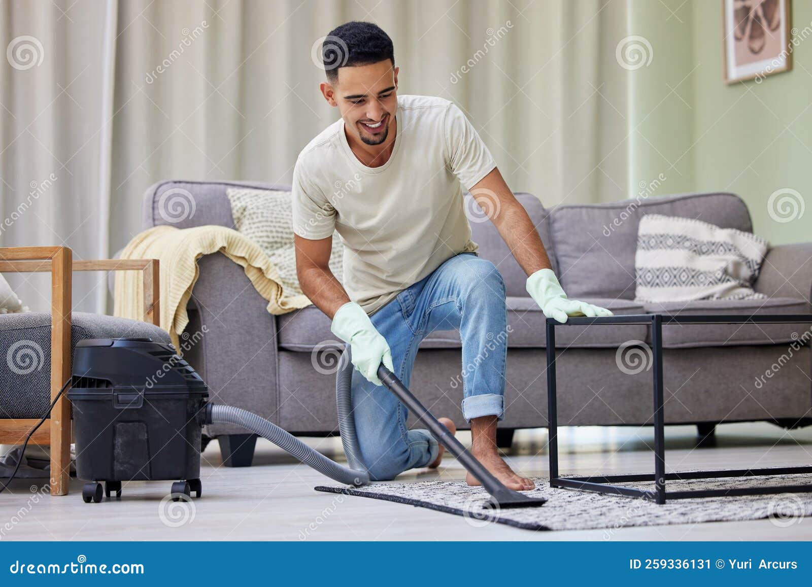 This Vacuum Gets the Job Done. a Young Man Vacuuming at Home. Stock