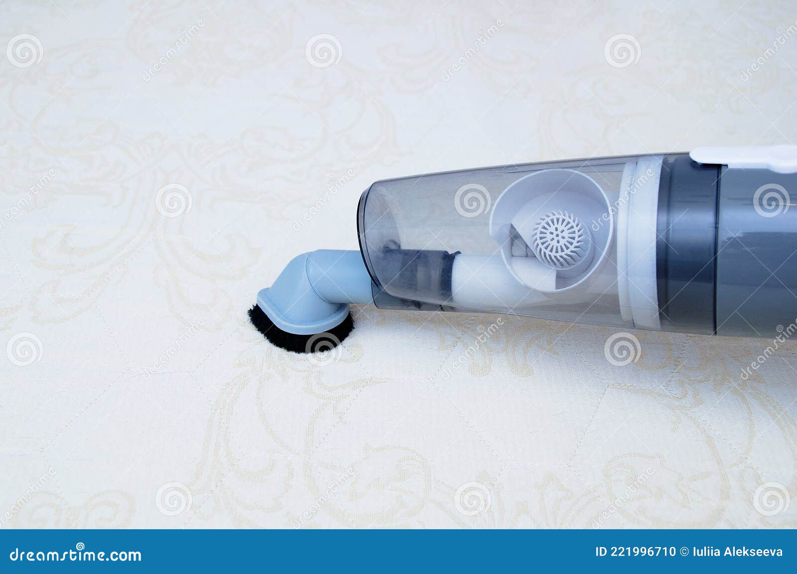 Vacuum the Mattress of the Bed with Handheld Vacuum Cleaner Closeup