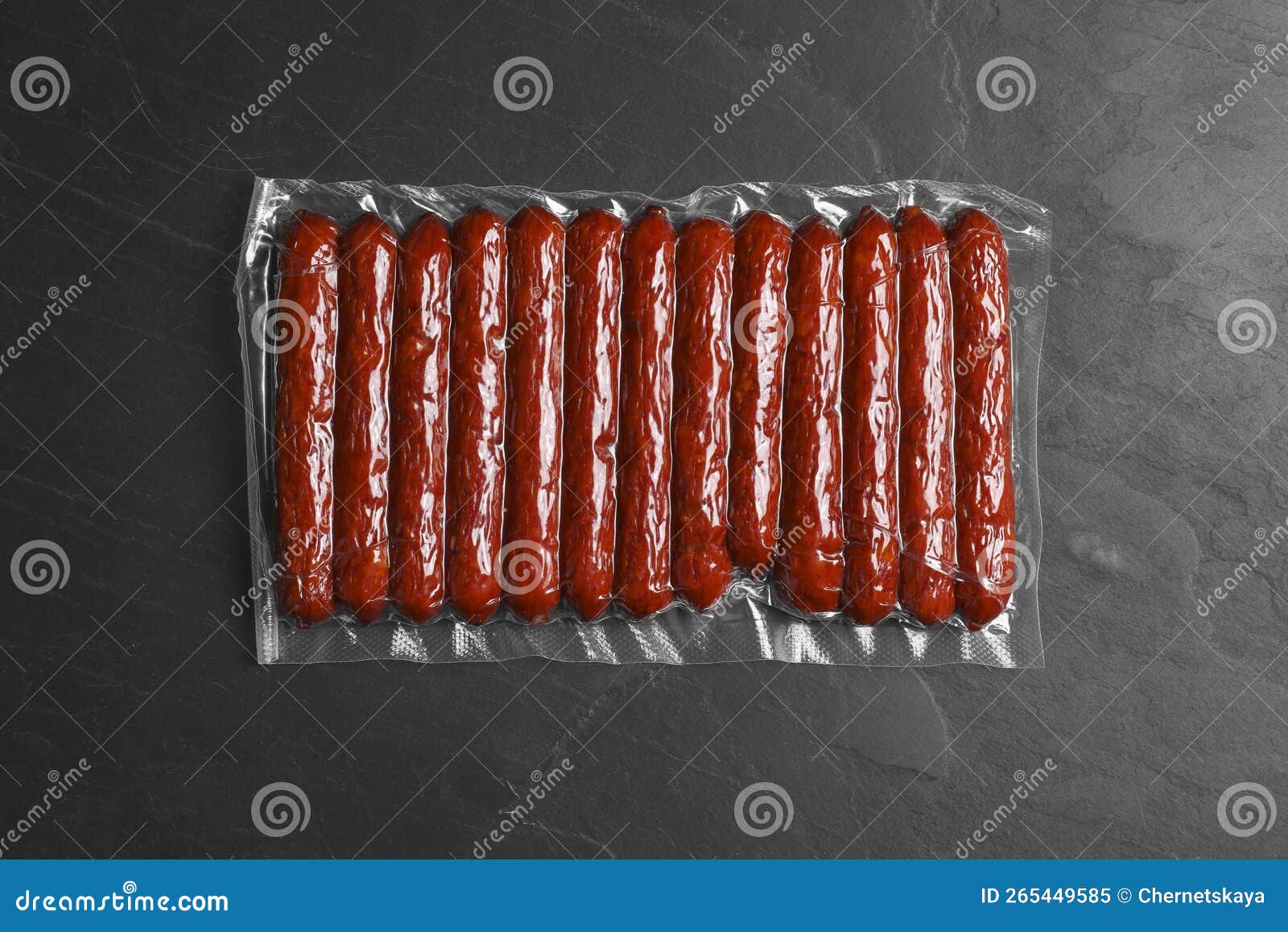 Vacuum Pack of Sausages on Dark Grey Table, Top View Stock Image