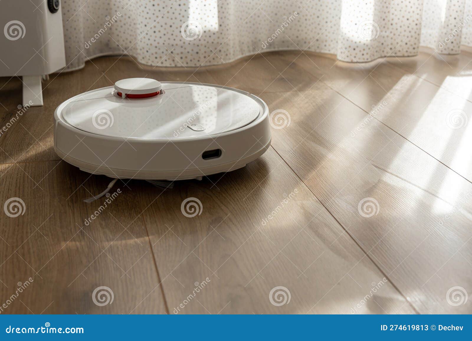 Vacuum Robot Cleaning at Home. Robot Vacuum Cleaner in the Modern Home