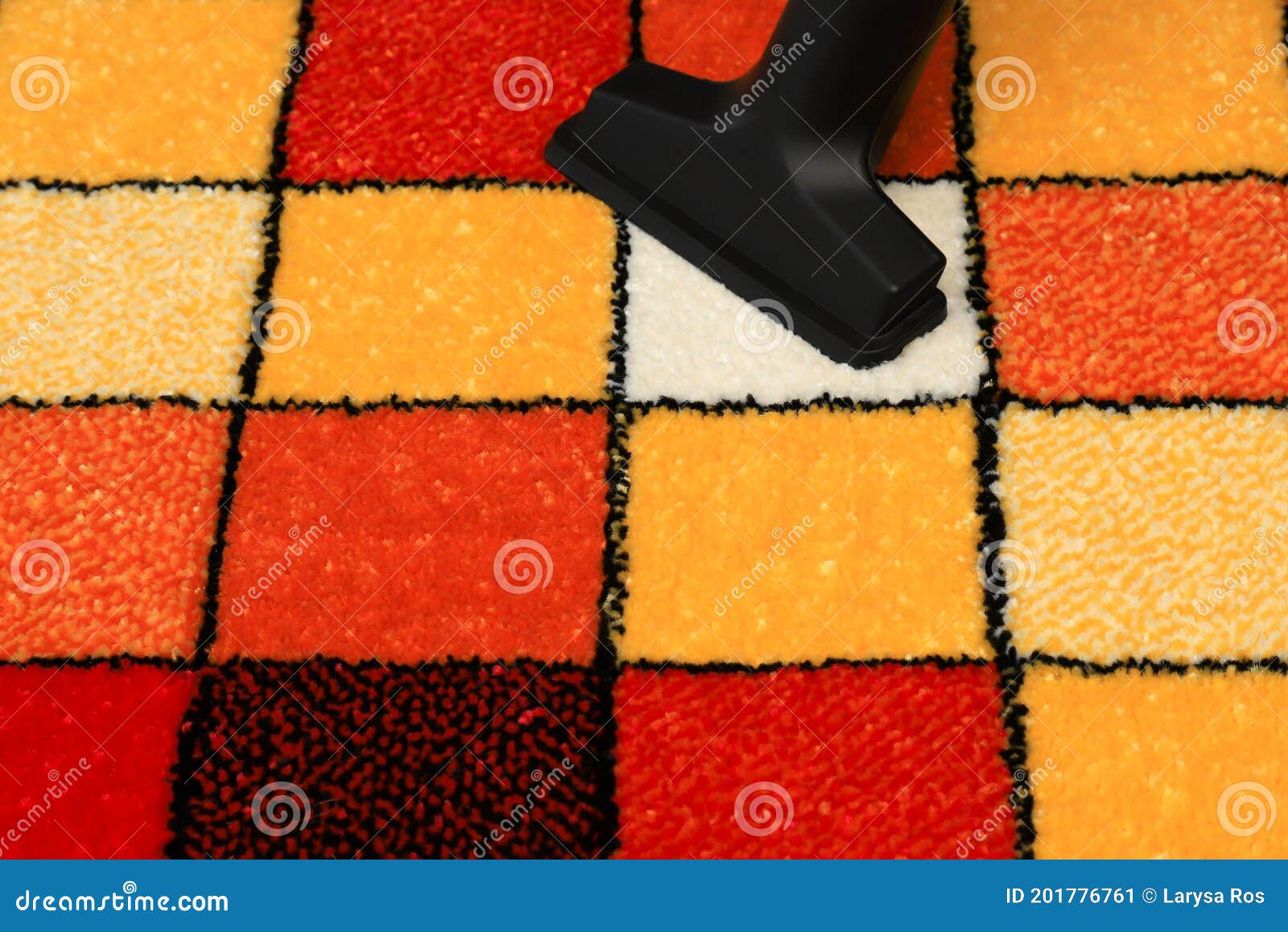 Vacuuming a Rug with a Pattern of Colored Squares. Fluffy Carpet