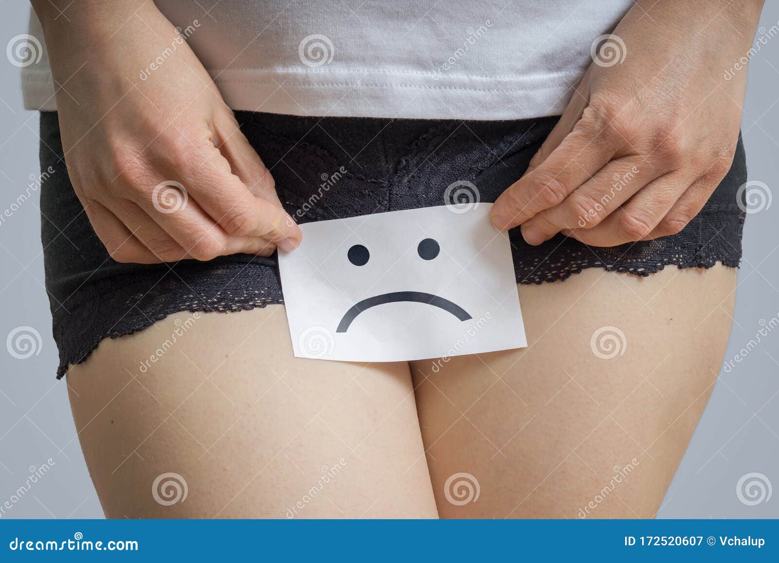 vaginal or menstrual problems concept. young woman holds paper with sos above crotch.