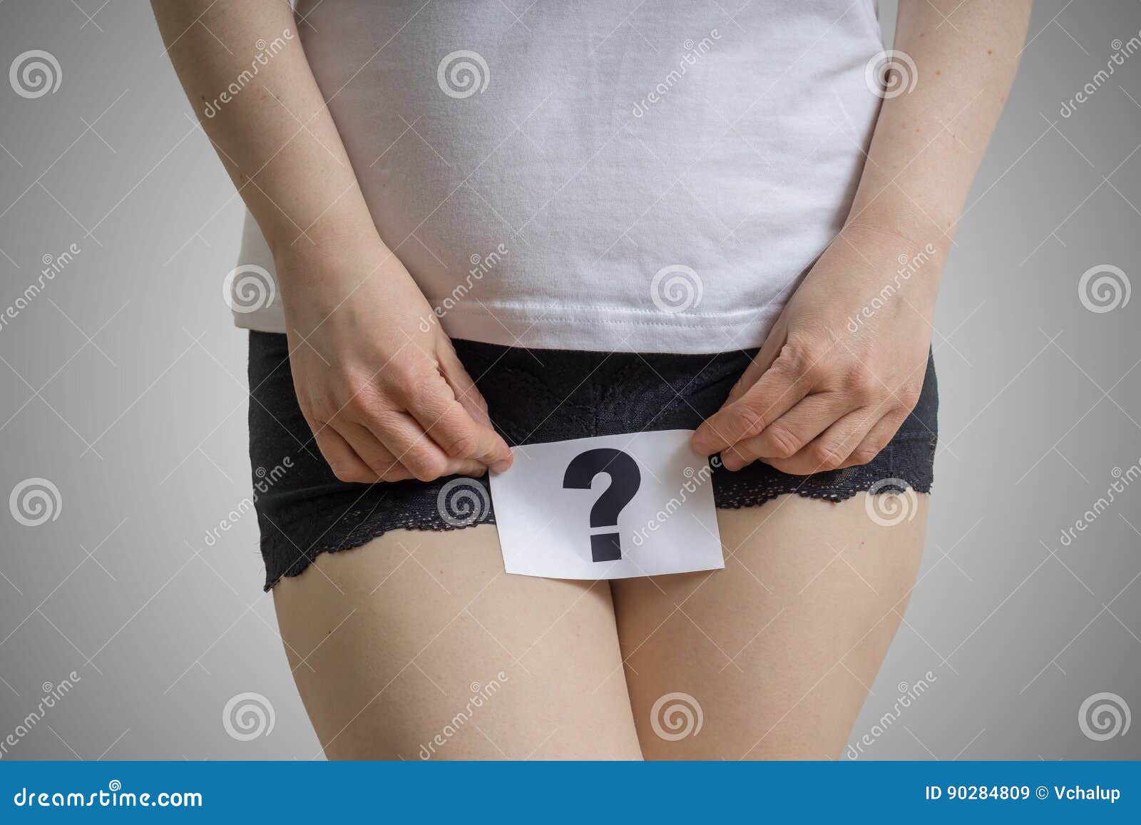 vaginal or urinary infection and problems concept. young woman holds paper with questionmark above crotch