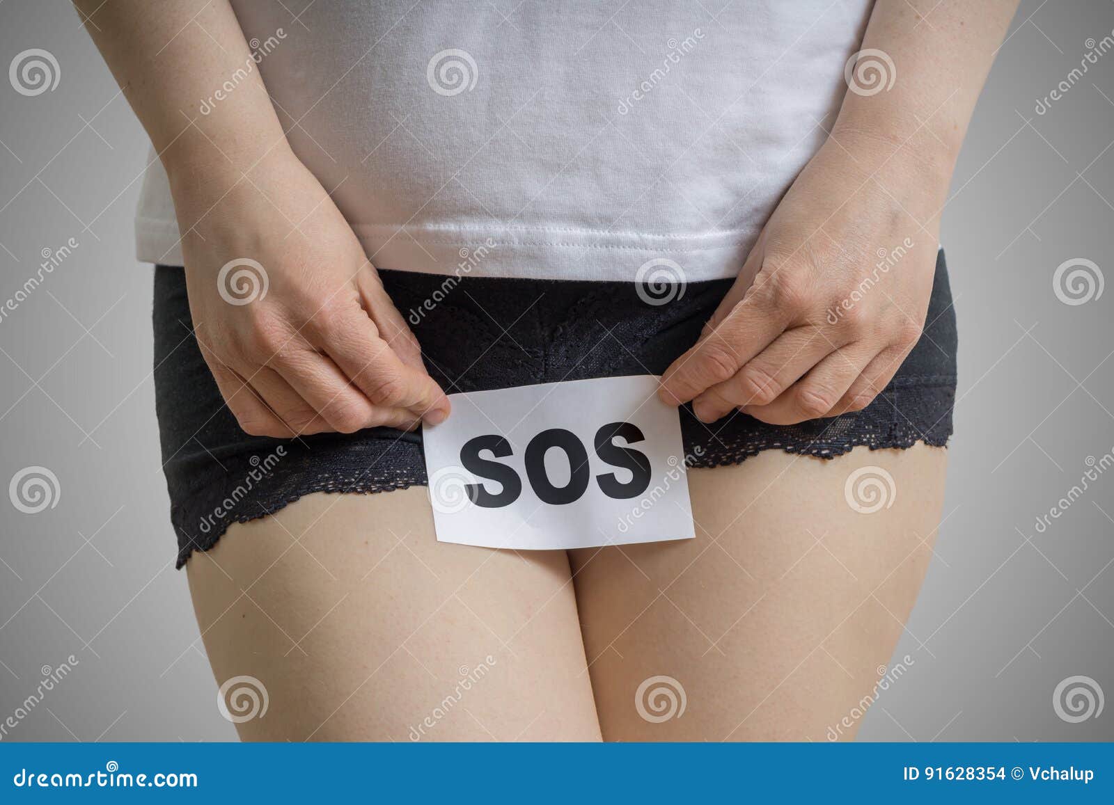 vaginal or urinary infection and problems concept. young woman holds paper with sos above crotch