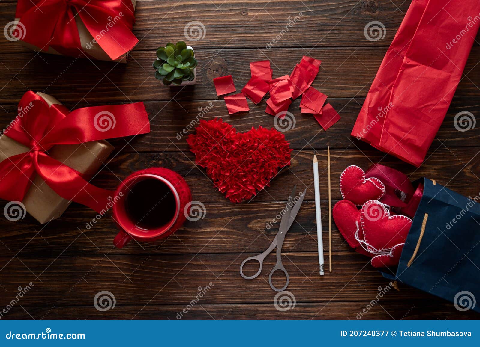 Valentine's Day concept. Gift with red bow on the wooden backgr