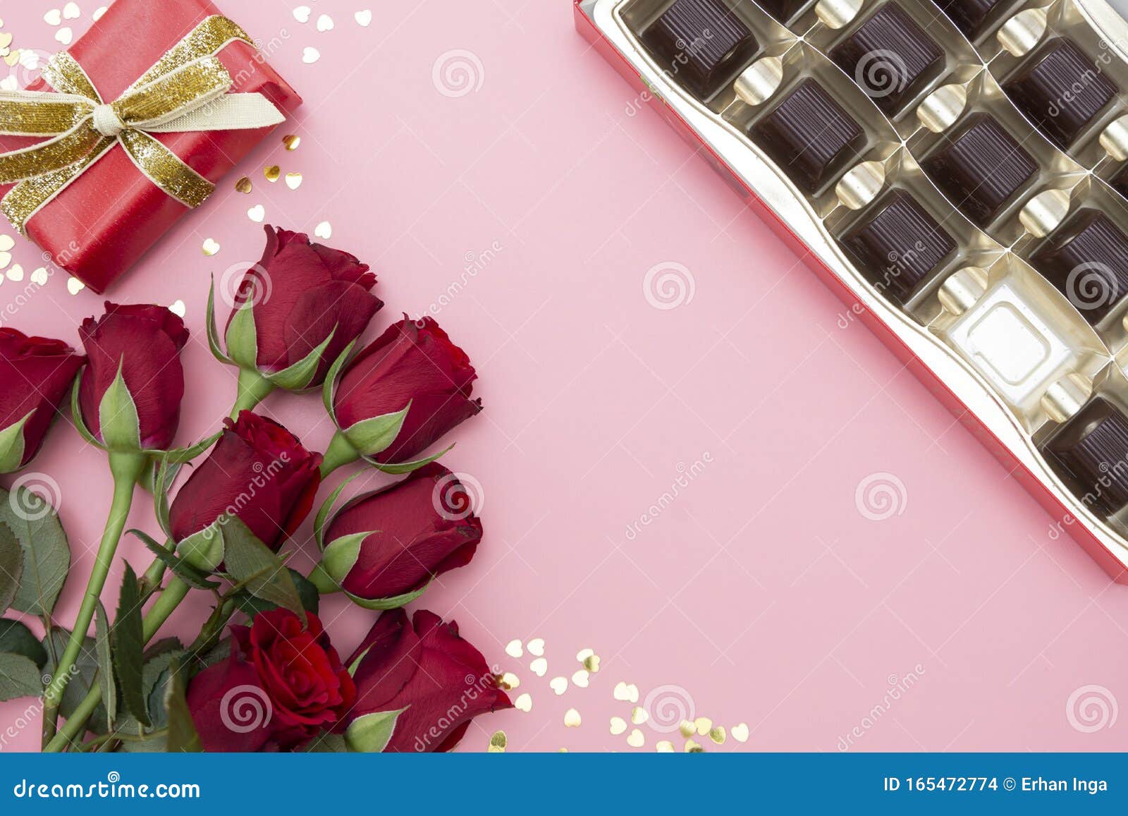 valentine`s day, red roses, gift boxes and chocolate box with ribbon, over pinkl background flat lay, birthday abstract