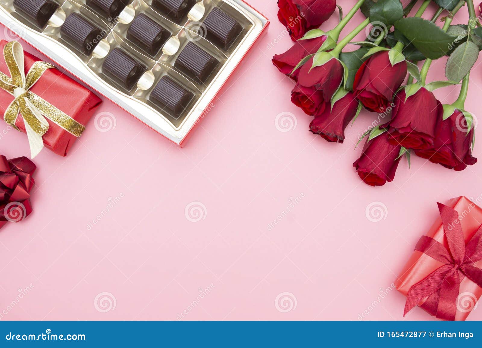 valentine`s day, red roses, gift boxes and chocolate box with ribbon, over pinkl background flat lay, birthday abstract