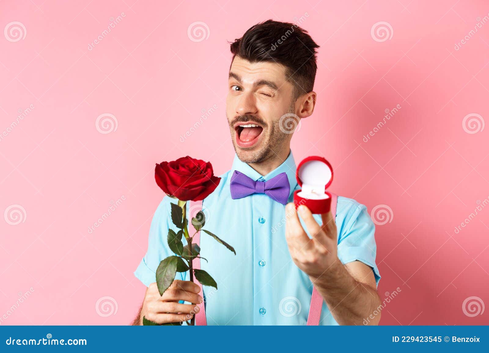 Valentines Day. Funny Guy Making Proposal, Winking and Saying Marry Me, Showing Engagement Ring with Red Rose, Standing Stock Image - Image of passionate, bowtie: 229423545 Valentines Day. Funny Guy Making Proposal, Winking and Saying Marry Me, Showing Engagement Ring with Red Rose, Standing Stock Image - Image of passionate, bowtie: 229423545