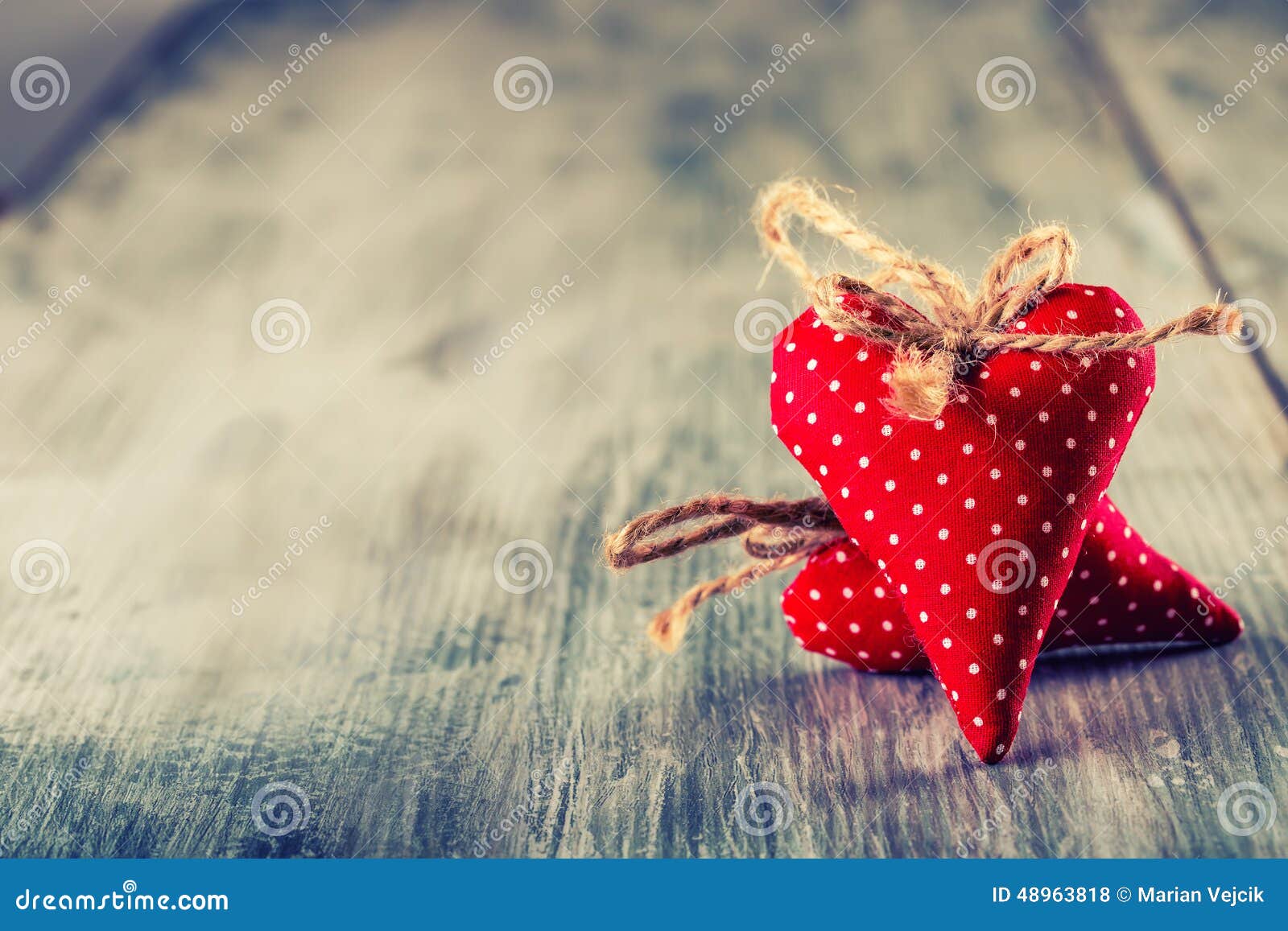 valentines day. red cloth handmade hearts on wooden background