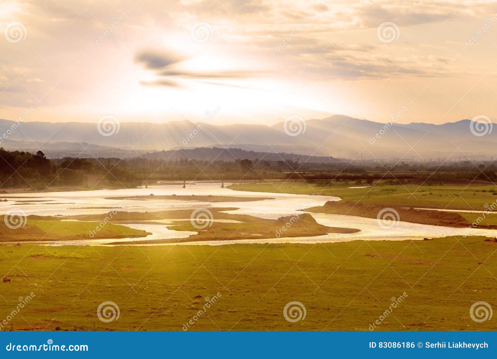 Valley view with river and mountains in the background at sunrise. Valley view from the river and the mountains in the background at sunrise. Georgia. Caucasus mountains