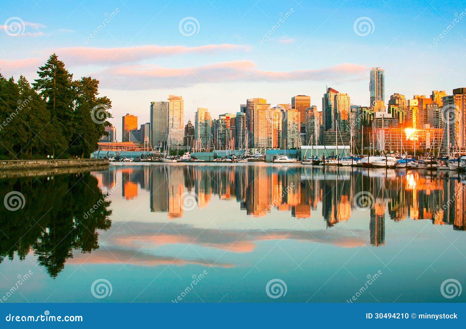 vancouver skyline with stanley park at sunset, british columbia, canada